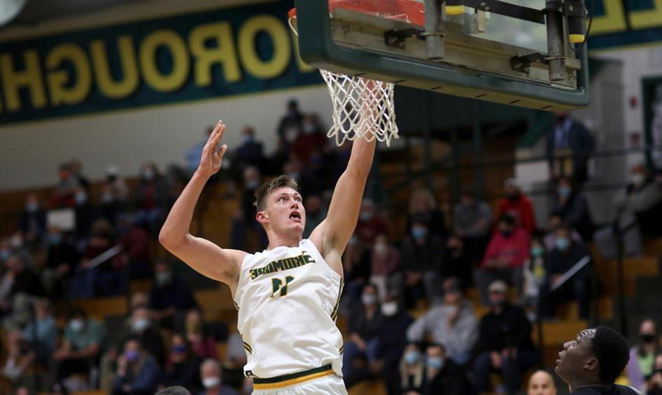 male basketball player jumps for a layup at the hoop